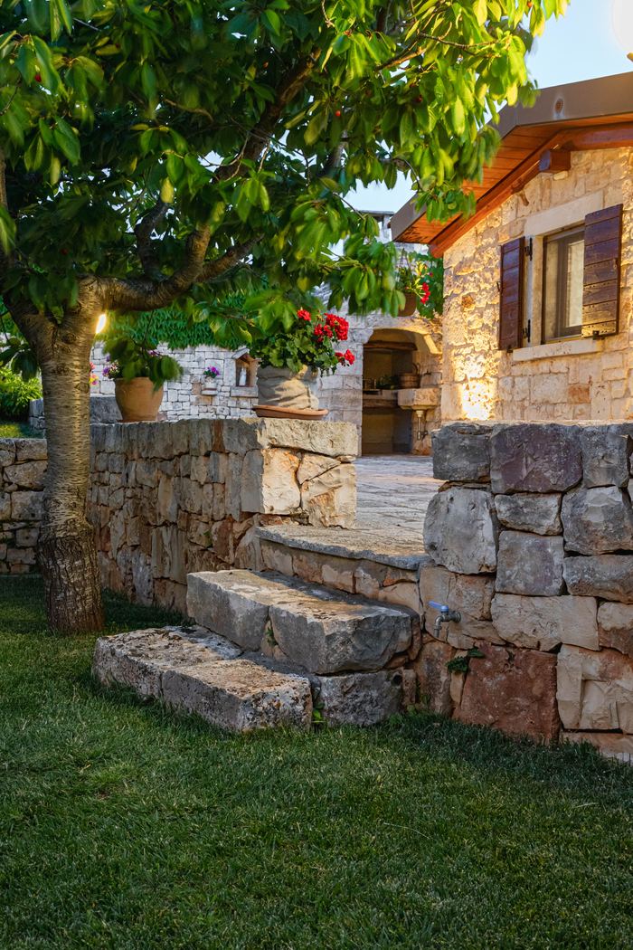 Gli scalini in pietra tra il giardino e il trullo
