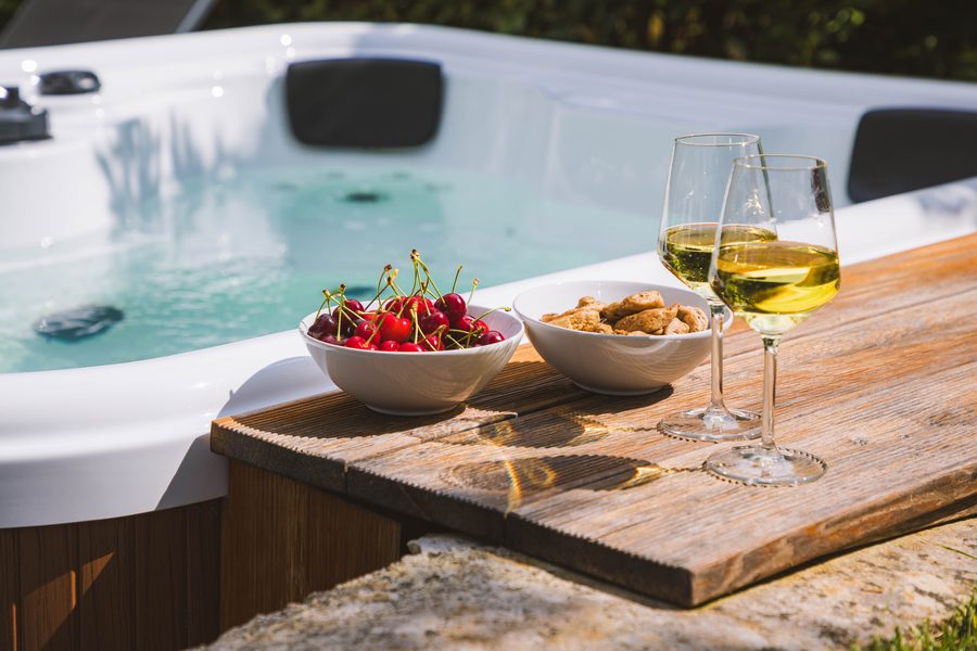 Calici di vino e frutta sul bordo della jacuzzi